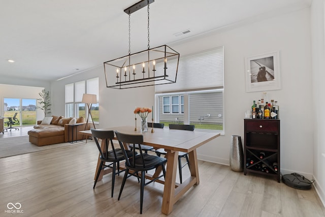 14848 Stonneger St, Westfield, IN 46074 - dining room featuring light wood finished floors, baseboards, and a chandelier