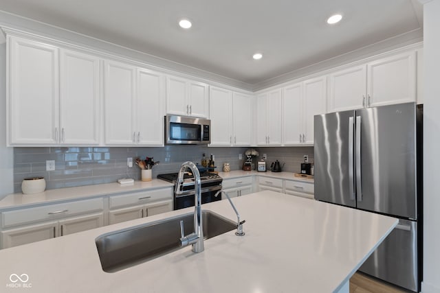 14848 Stonneger St, Westfield, IN 46074 - kitchen featuring stainless steel appliances, white cabinetry, light countertops, tasteful backsplash, and recessed lighting