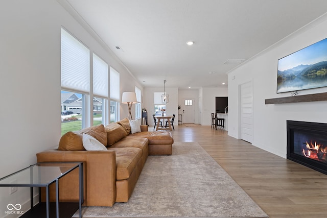 14848 Stonneger St, Westfield, IN 46074 - living area featuring light wood-style flooring, a glass covered fireplace, and recessed lighting