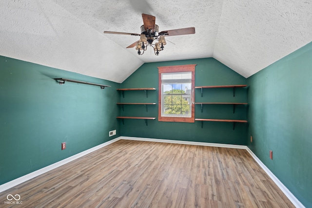 10693 Newgate Ln, Indianapolis, IN 46231 - bonus room with wood finished floors, a ceiling fan, a textured ceiling, vaulted ceiling, and baseboards