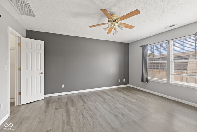 10693 Newgate Ln, Indianapolis, IN 46231 - spare room with wood finished floors, a textured ceiling, a ceiling fan, and baseboards