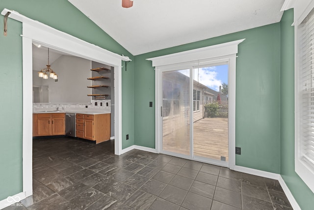 10693 Newgate Ln, Indianapolis, IN 46231 - unfurnished dining area featuring lofted ceiling, baseboards, a chandelier, dark stone finish floors, and a sink