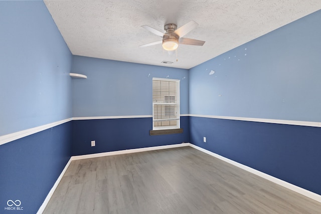 10693 Newgate Ln, Indianapolis, IN 46231 - unfurnished room featuring wood finished floors, ceiling fan, a textured ceiling, and baseboards