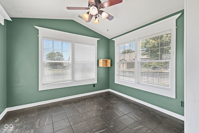 10693 Newgate Ln, Indianapolis, IN 46231 - empty room featuring baseboards, lofted ceiling, a ceiling fan, and stone tile floors