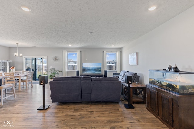 7834 Fairwood Blvd, Plainfield, IN 46168 - living room with plenty of natural light, a textured ceiling, wood finished floors, recessed lighting, and a chandelier