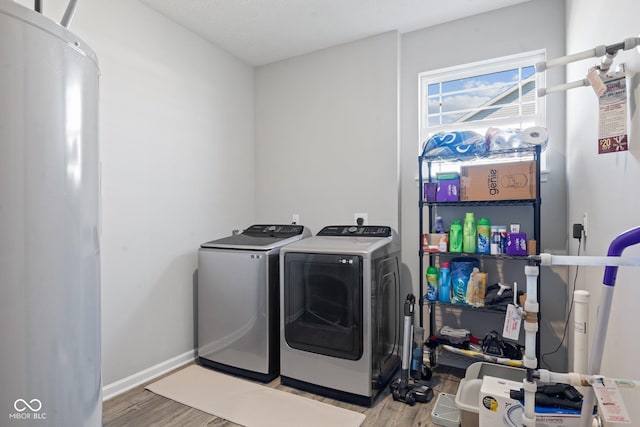 7834 Fairwood Blvd, Plainfield, IN 46168 - washroom with washing machine and dryer, light wood-style flooring, water heater, and baseboards