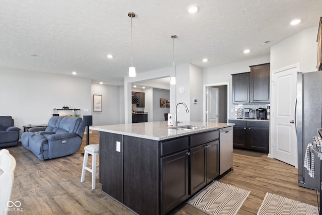 7834 Fairwood Blvd, Plainfield, IN 46168 - kitchen with a sink, open floor plan, stainless steel dishwasher, wood finished floors, and an island with sink