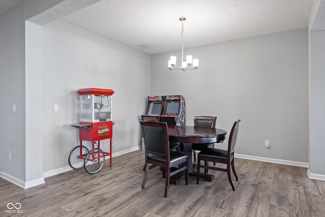 7834 Fairwood Blvd, Plainfield, IN 46168 - dining room featuring a chandelier, wood finished floors, and baseboards