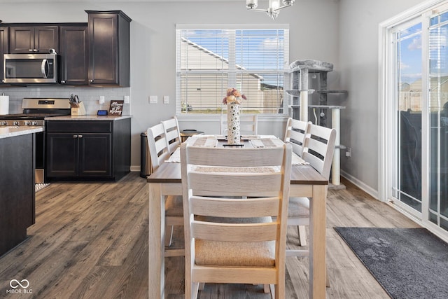 7834 Fairwood Blvd, Plainfield, IN 46168 - dining space with light wood-type flooring, a chandelier, and baseboards
