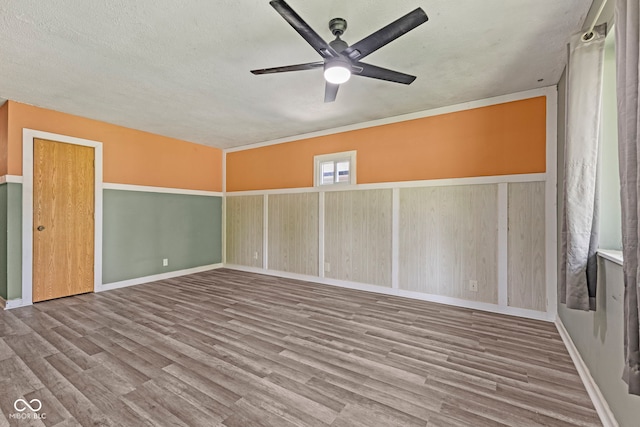 3898 S Randolph St, Indianapolis, IN 46227 - spare room featuring wood finished floors, a ceiling fan, and a textured ceiling