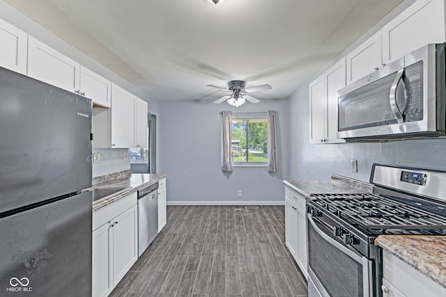 3898 S Randolph St, Indianapolis, IN 46227 - kitchen featuring appliances with stainless steel finishes, ceiling fan, white cabinets, and dark wood-style floors