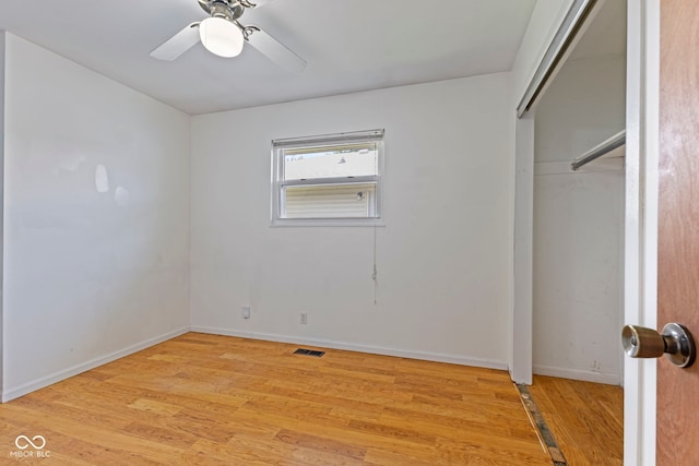 3898 S Randolph St, Indianapolis, IN 46227 - unfurnished bedroom with light wood-style flooring, ceiling fan, and a closet