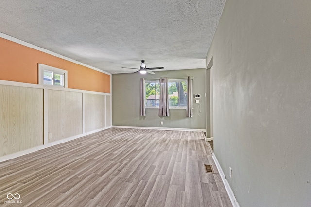 3898 S Randolph St, Indianapolis, IN 46227 - unfurnished room with wood finished floors, a textured ceiling, healthy amount of natural light, and a ceiling fan