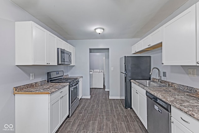 3898 S Randolph St, Indianapolis, IN 46227 - kitchen with appliances with stainless steel finishes, separate washer and dryer, white cabinetry, and dark wood-style flooring