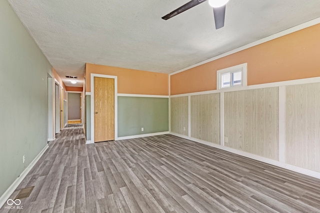 3898 S Randolph St, Indianapolis, IN 46227 - empty room featuring wood finished floors, a ceiling fan, and a textured ceiling