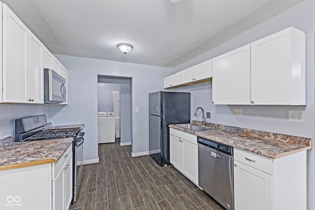 3898 S Randolph St, Indianapolis, IN 46227 - kitchen featuring appliances with stainless steel finishes, white cabinetry, independent washer and dryer, and dark wood-style flooring