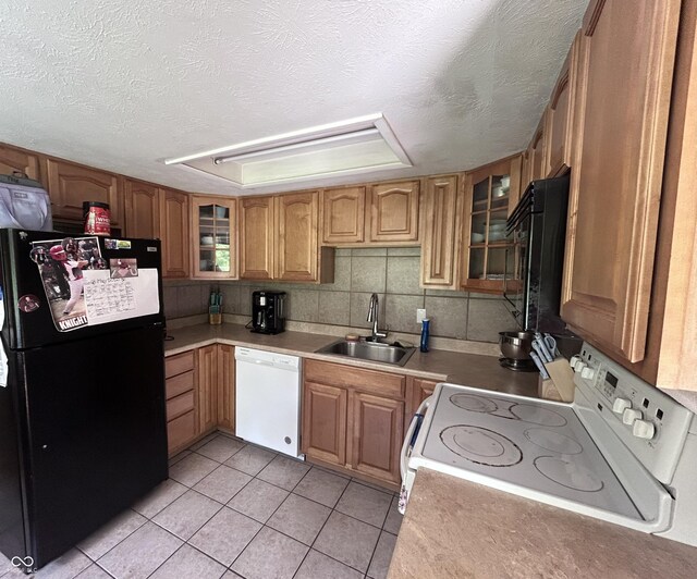 5174 S Greensboro Pike, Knightstown, IN 46148 - kitchen featuring black appliances, a sink, light countertops, light tile patterned floors, and glass insert cabinets