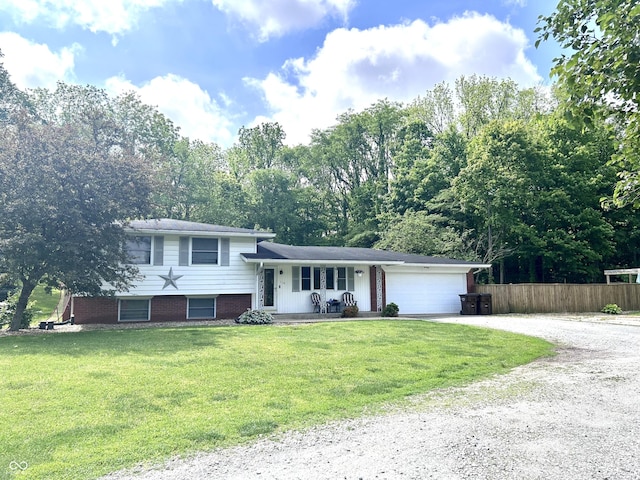 5174 S Greensboro Pike, Knightstown, IN 46148 - tri-level home featuring driveway, covered porch, an attached garage, and brick siding