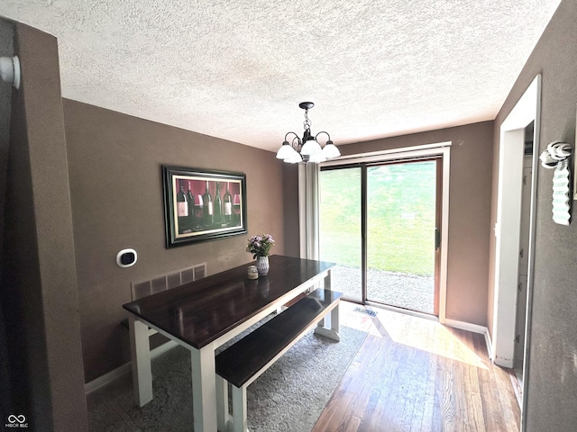 5174 S Greensboro Pike, Knightstown, IN 46148 - dining area featuring wood-type flooring, a chandelier, baseboards, and a textured ceiling