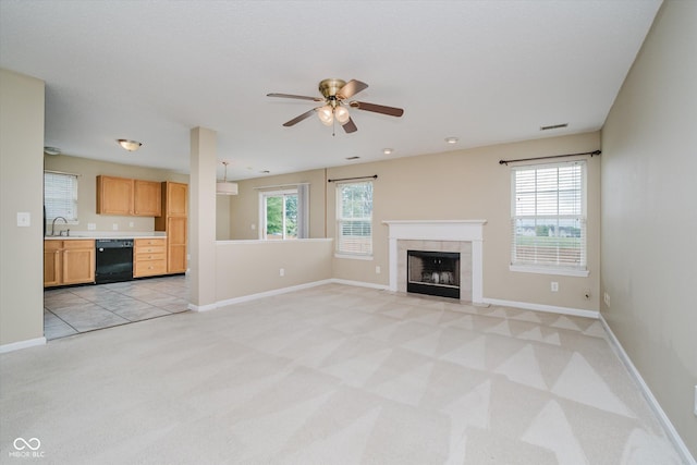 5258 Brassie Dr, Indianapolis, IN 46235 - unfurnished living room with a sink, light colored carpet, a ceiling fan, a tile fireplace, and baseboards