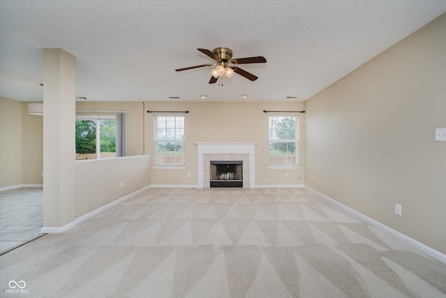 5258 Brassie Dr, Indianapolis, IN 46235 - unfurnished living room with a ceiling fan, light carpet, a fireplace, and healthy amount of natural light
