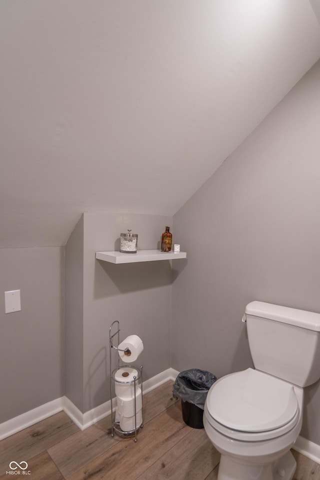 5315 Camden St, Indianapolis, IN 46227 - bathroom with wood finished floors, toilet, baseboards, and vaulted ceiling