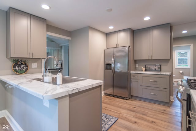 5315 Camden St, Indianapolis, IN 46227 - kitchen with appliances with stainless steel finishes, gray cabinets, a sink, light wood finished floors, and recessed lighting