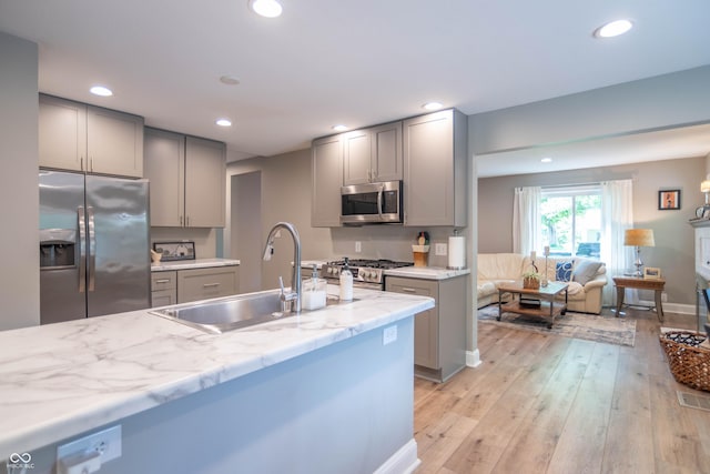 5315 Camden St, Indianapolis, IN 46227 - kitchen with appliances with stainless steel finishes, gray cabinets, a sink, recessed lighting, and light wood-type flooring
