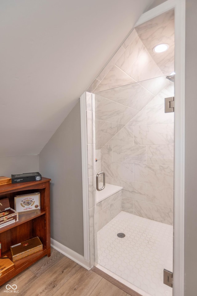 5315 Camden St, Indianapolis, IN 46227 - bathroom with a stall shower, wood finished floors, baseboards, and vaulted ceiling