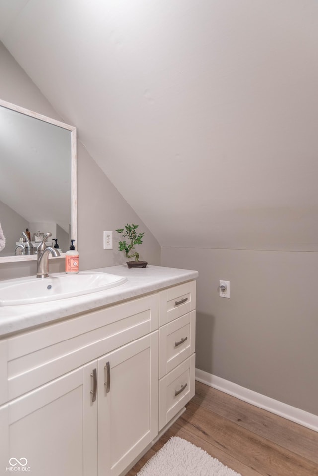 5315 Camden St, Indianapolis, IN 46227 - bathroom with vaulted ceiling, vanity, wood finished floors, and baseboards