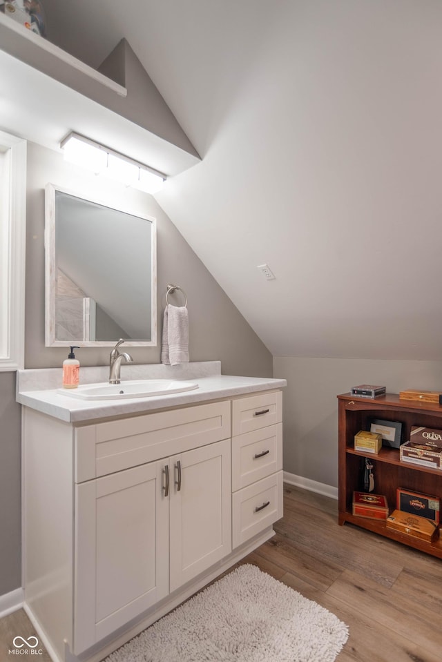 5315 Camden St, Indianapolis, IN 46227 - bathroom featuring lofted ceiling, wood finished floors, vanity, and baseboards