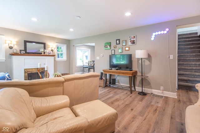 5315 Camden St, Indianapolis, IN 46227 - living room with light wood finished floors, stairs, recessed lighting, a fireplace, and baseboards