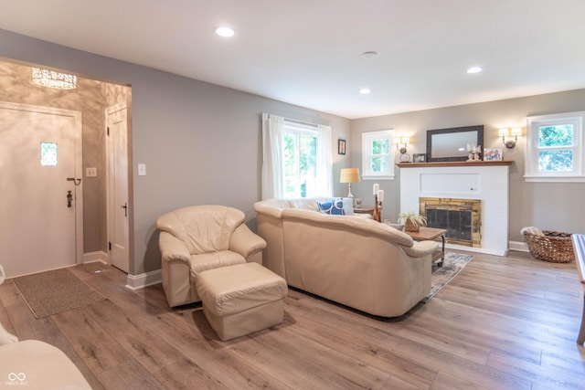5315 Camden St, Indianapolis, IN 46227 - living room featuring light wood finished floors, a glass covered fireplace, recessed lighting, and baseboards