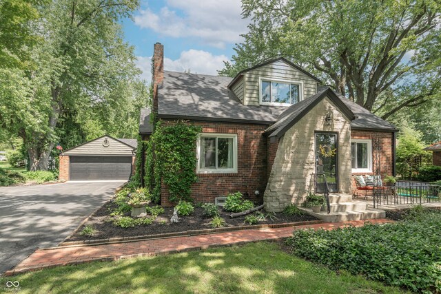 5315 Camden St, Indianapolis, IN 46227 - view of front of home with a detached garage, a chimney, brick siding, and an outdoor structure