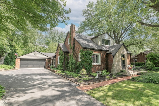 5315 Camden St, Indianapolis, IN 46227 - view of front of house featuring driveway, brick siding, a shingled roof, an attached garage, and a chimney