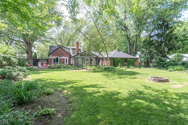 5315 Camden St, Indianapolis, IN 46227 - view of front facade featuring an outdoor fire pit, a chimney, and brick siding