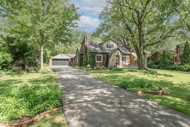 5315 Camden St, Indianapolis, IN 46227 - tudor house featuring a front yard and asphalt driveway