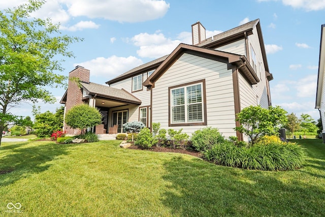 1521 Avondale Dr, Westfield, IN 46074 - rear view of property with a chimney and a yard