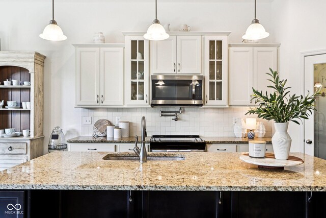 1521 Avondale Dr, Westfield, IN 46074 - kitchen with stainless steel appliances, a sink, decorative backsplash, and light stone counters