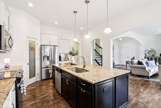 1521 Avondale Dr, Westfield, IN 46074 - kitchen featuring arched walkways, a sink, stainless steel appliances, dark wood-type flooring, and white cabinets