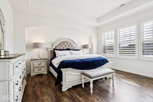 1521 Avondale Dr, Westfield, IN 46074 - bedroom featuring multiple windows, dark wood-style floors, a tray ceiling, and baseboards