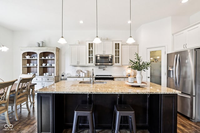 1521 Avondale Dr, Westfield, IN 46074 - kitchen with stainless steel appliances, a sink, dark wood-style flooring, tasteful backsplash, and white cabinetry