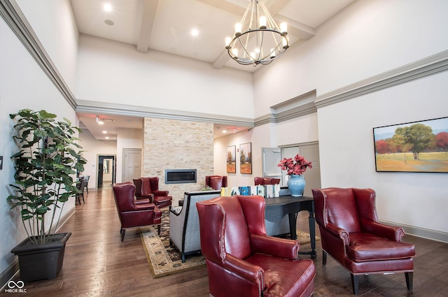 1521 Avondale Dr, Westfield, IN 46074 - living room with a towering ceiling, a chandelier, baseboards, wood finished floors, and a stone fireplace