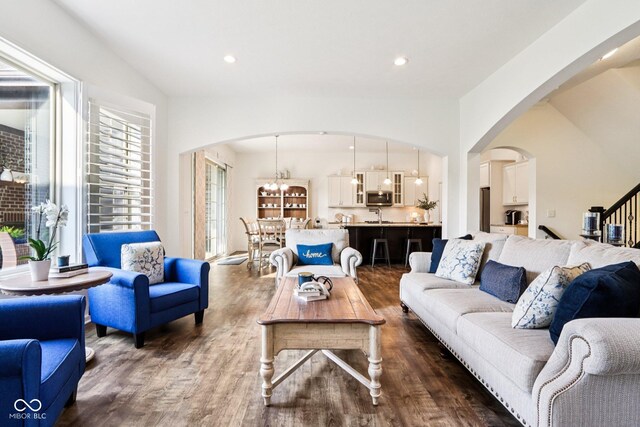 1521 Avondale Dr, Westfield, IN 46074 - living area featuring arched walkways, dark wood-style flooring, stairs, and recessed lighting