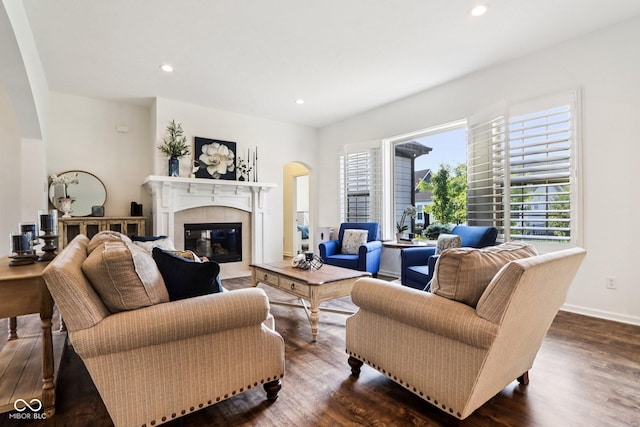 1521 Avondale Dr, Westfield, IN 46074 - living room featuring arched walkways, plenty of natural light, a tiled fireplace, dark wood-style flooring, and recessed lighting