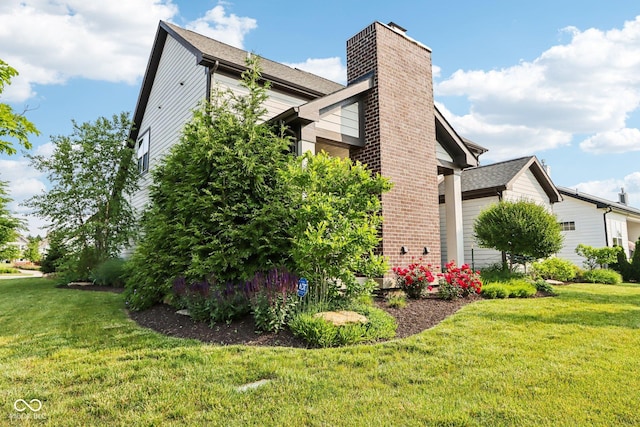 1521 Avondale Dr, Westfield, IN 46074 - view of side of home with a chimney, a yard, and an attached garage