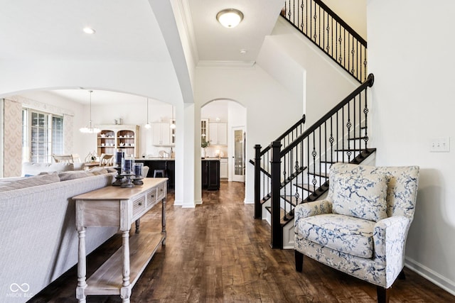 1521 Avondale Dr, Westfield, IN 46074 - foyer with arched walkways, dark wood-style flooring, stairs, a towering ceiling, and baseboards