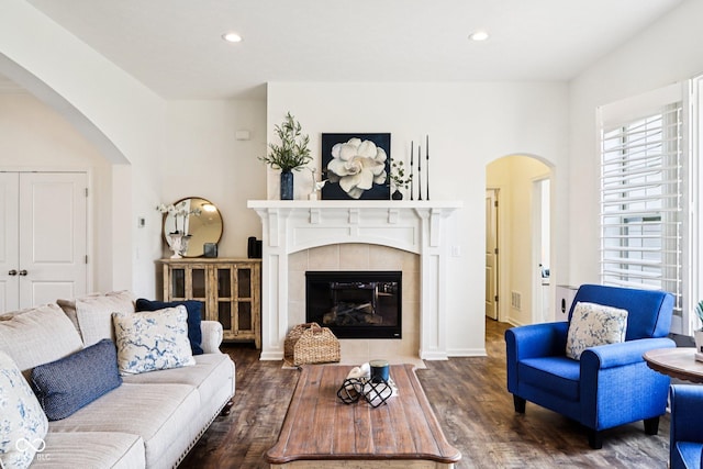 1521 Avondale Dr, Westfield, IN 46074 - living area with wood finished floors, recessed lighting, a tiled fireplace, arched walkways, and baseboards