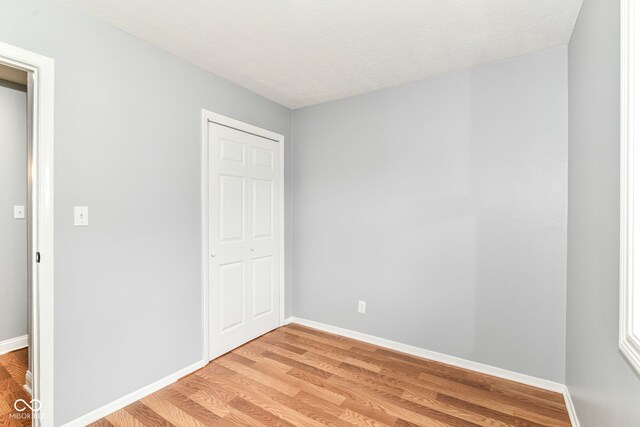 8445 Montery Rd, Indianapolis, IN 46226 - unfurnished bedroom with light wood-type flooring, baseboards, and a closet