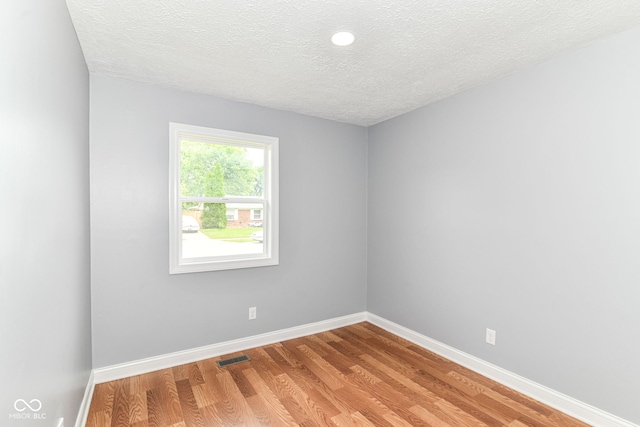 8445 Montery Rd, Indianapolis, IN 46226 - empty room with a textured ceiling, light wood-type flooring, and baseboards